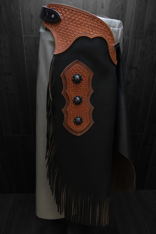 Brown leather chinks with decorative accents and conchos