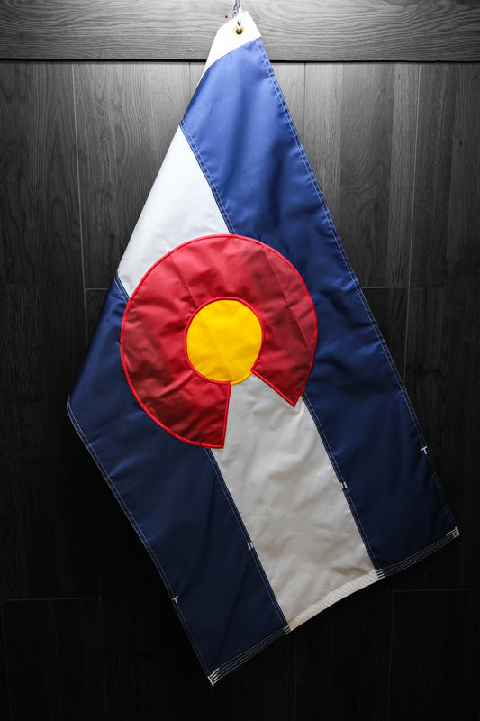 colorado flag hanging on a dark background
