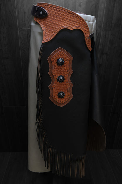 Brown leather chinks with decorative accents and conchos