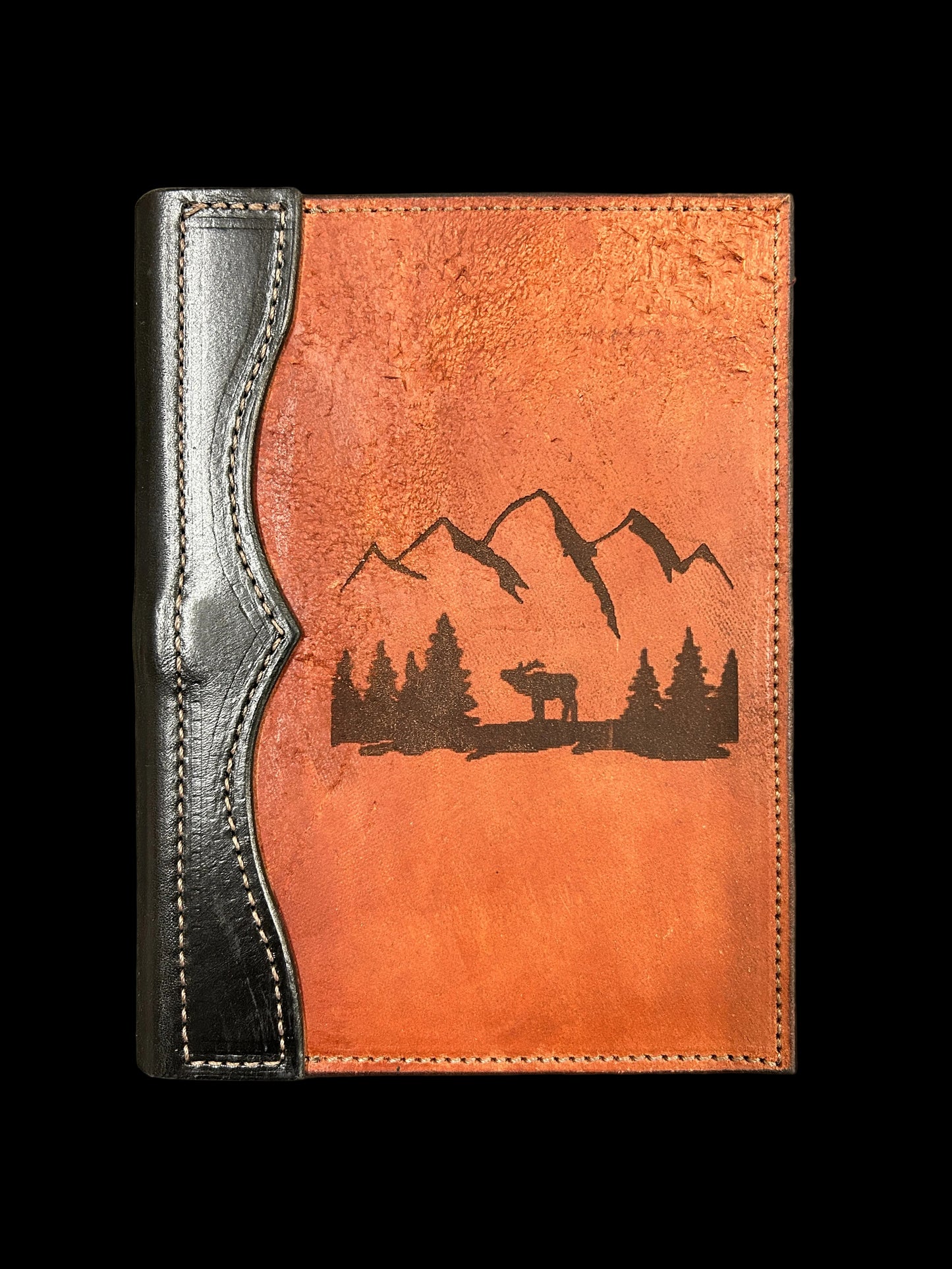leather padfolio with laser image of elk among trees without mountain background