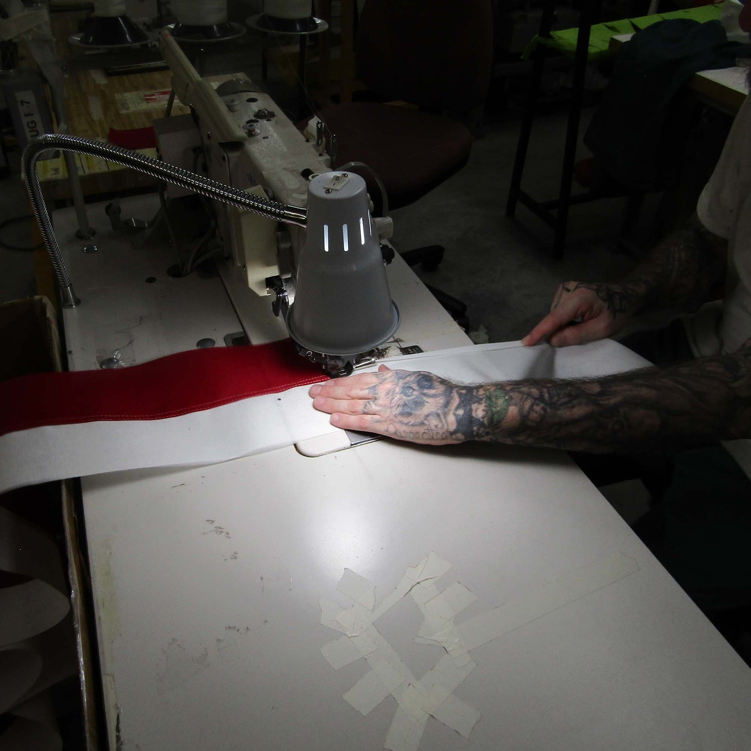 worker sewing a flag